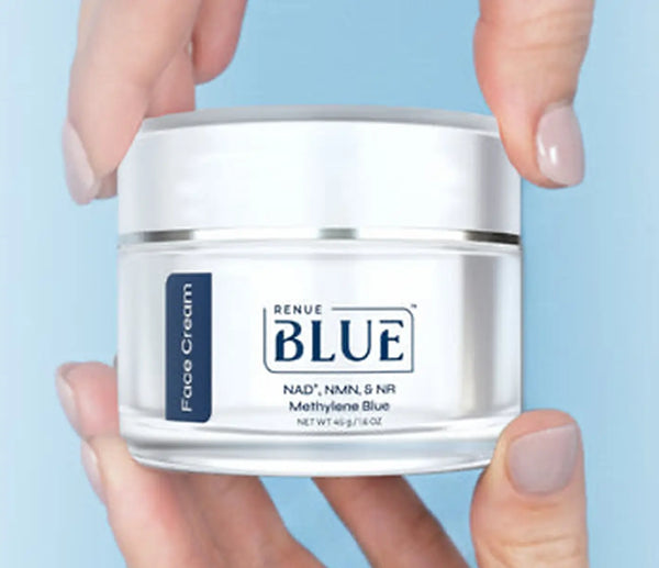 Jar of Renue Blue face cream held by a person against a light blue background