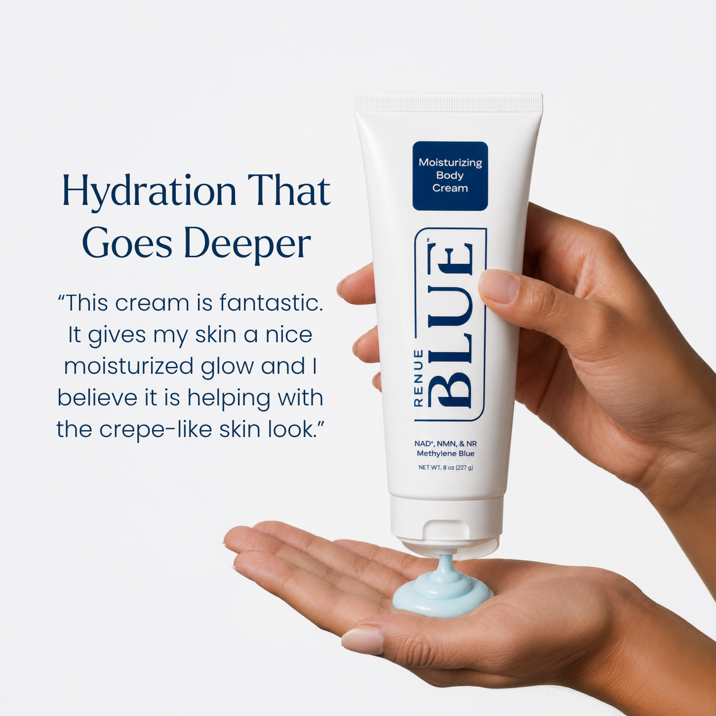 A hand holds a white tube of Renue Blue Moisturizing Body Cream, with the cream being squeezed into an open palm. The background is a clean, light gray studio backdrop with promotional text on the left.