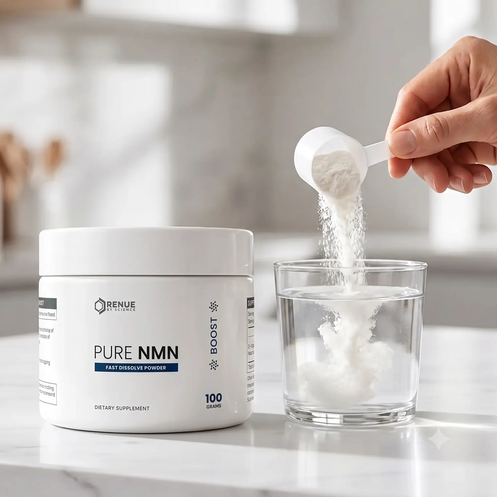A white tub of Renue Labs Pure NMN dietary supplement powder sits on a countertop beside a clear glass being filled with water, with a hand holding a scoop of the powder above the glass.