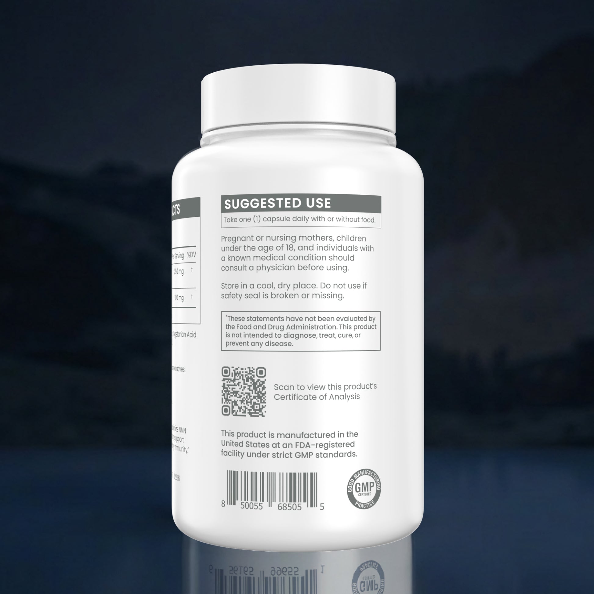 A white plastic supplement bottle shown from the back, featuring a white cap and a white label with black text sections including 'SUGGESTED USE', a QR code, and a GMP seal, set against a dark blue reflective background.