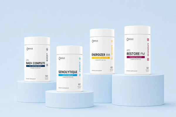 Four white cylindrical supplement bottles from the brand Omnilife, displayed on light blue pedestals against a pale blue background. The bottles are labeled: NAD+ COMPLETE, SENOLYTIQUE, ENERGIZER AM, and RESTORE PM.