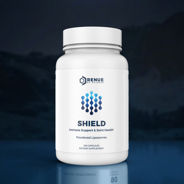 A white bottle of Renue Sciences Shield dietary supplement with a white cap, set against a dark blue, misty background with a subtle reflection on the surface below.