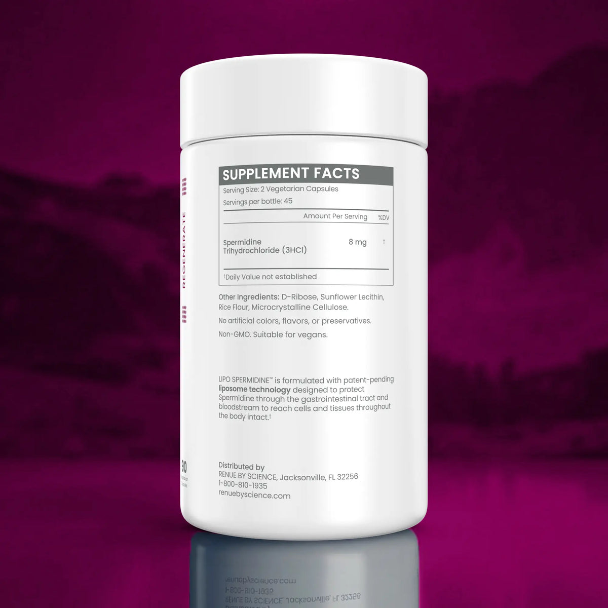 A white plastic bottle of USP Spromine dietary supplement capsules, showing the back of the label with supplement facts, set against a dark magenta gradient background with a reflection below.