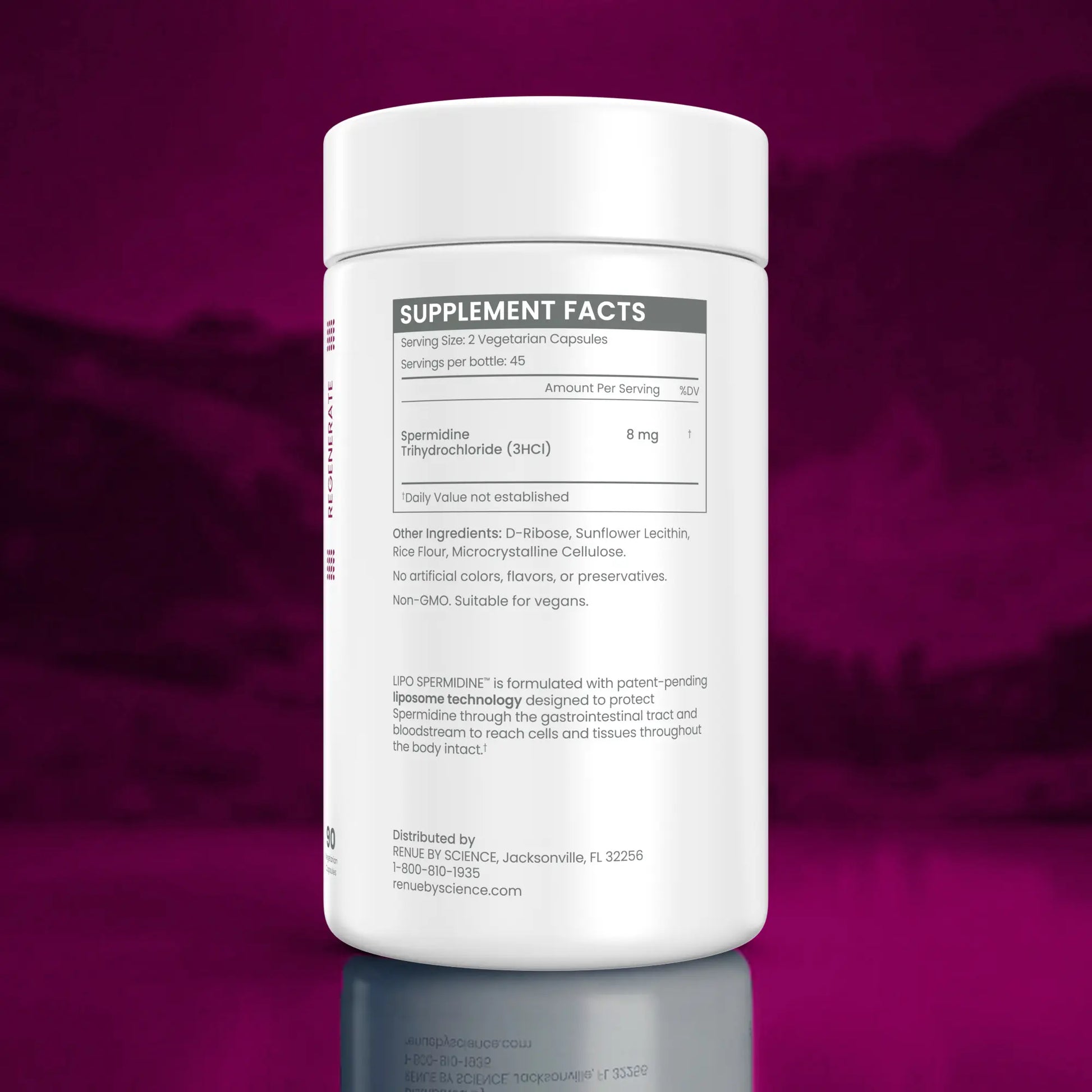 A white plastic bottle of USP Spromine dietary supplement capsules, showing the back of the label with supplement facts, set against a dark magenta gradient background with a reflection below.