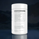 A white plastic bottle of UPNMD Complexe dietary supplement facts label, shown on a dark blue reflective background.