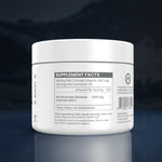 A white plastic tub of a dietary supplement with a white lid, showing the back label with 'Supplement Facts' and other ingredients, set against a dark blue gradient background with a reflection below.
