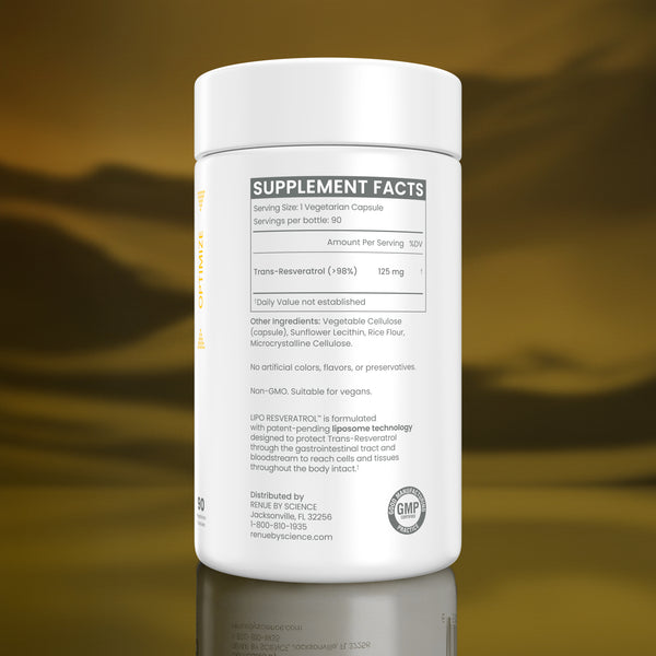 A white plastic bottle of HHRV Science Trans-Revevelator dietary supplement, showing the back of the label with supplement facts, a GMP seal, and a logo, set against a reflective golden-brown background.