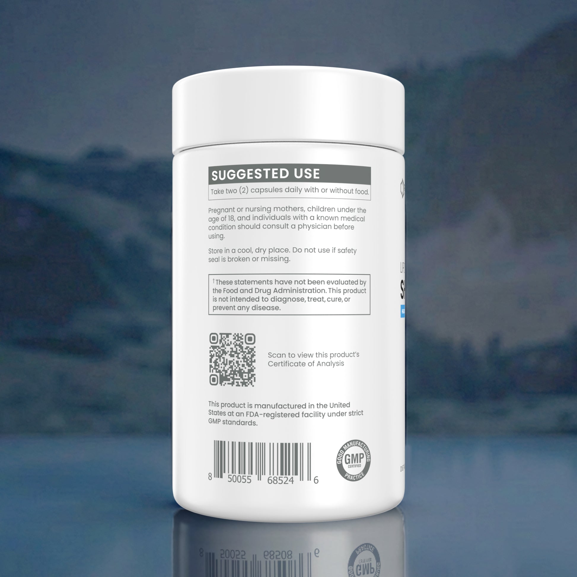 A white plastic supplement bottle shown from the back, featuring a white label with black text, a QR code, and a GMP seal, set against a dark blue reflective background.