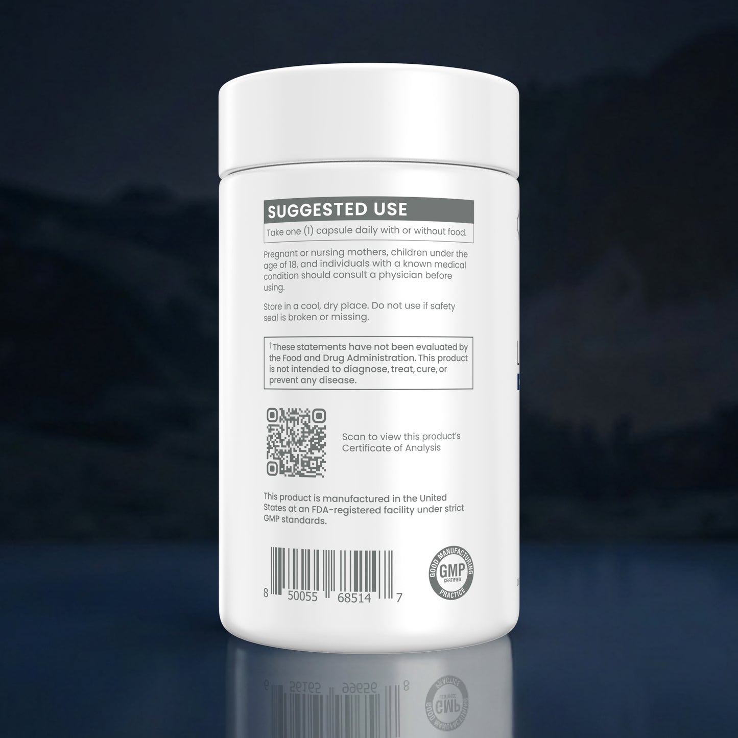 A white plastic supplement bottle shown from the back, featuring a white label with black and gray text, a QR code, and a GMP seal, set against a dark blue gradient background with a reflection below.