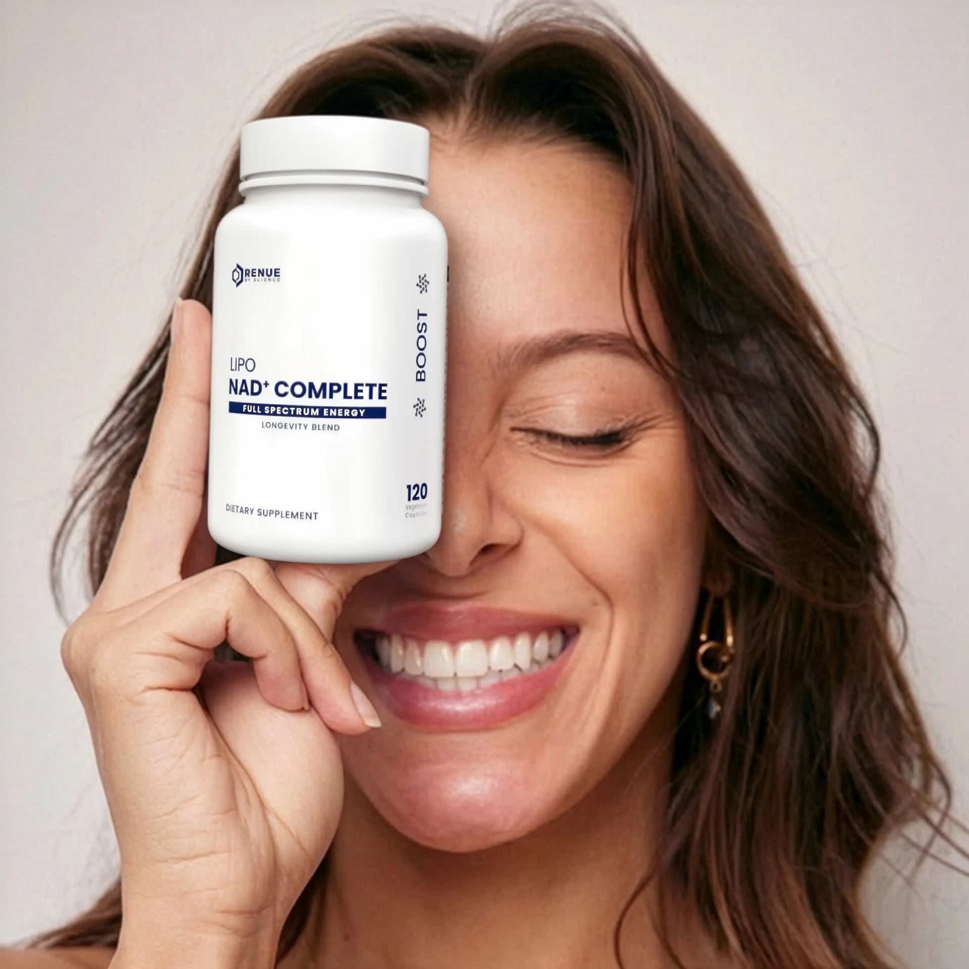 Woman holding a supplement bottle labeled 'Lipo NAD+ Complete' close to her face.