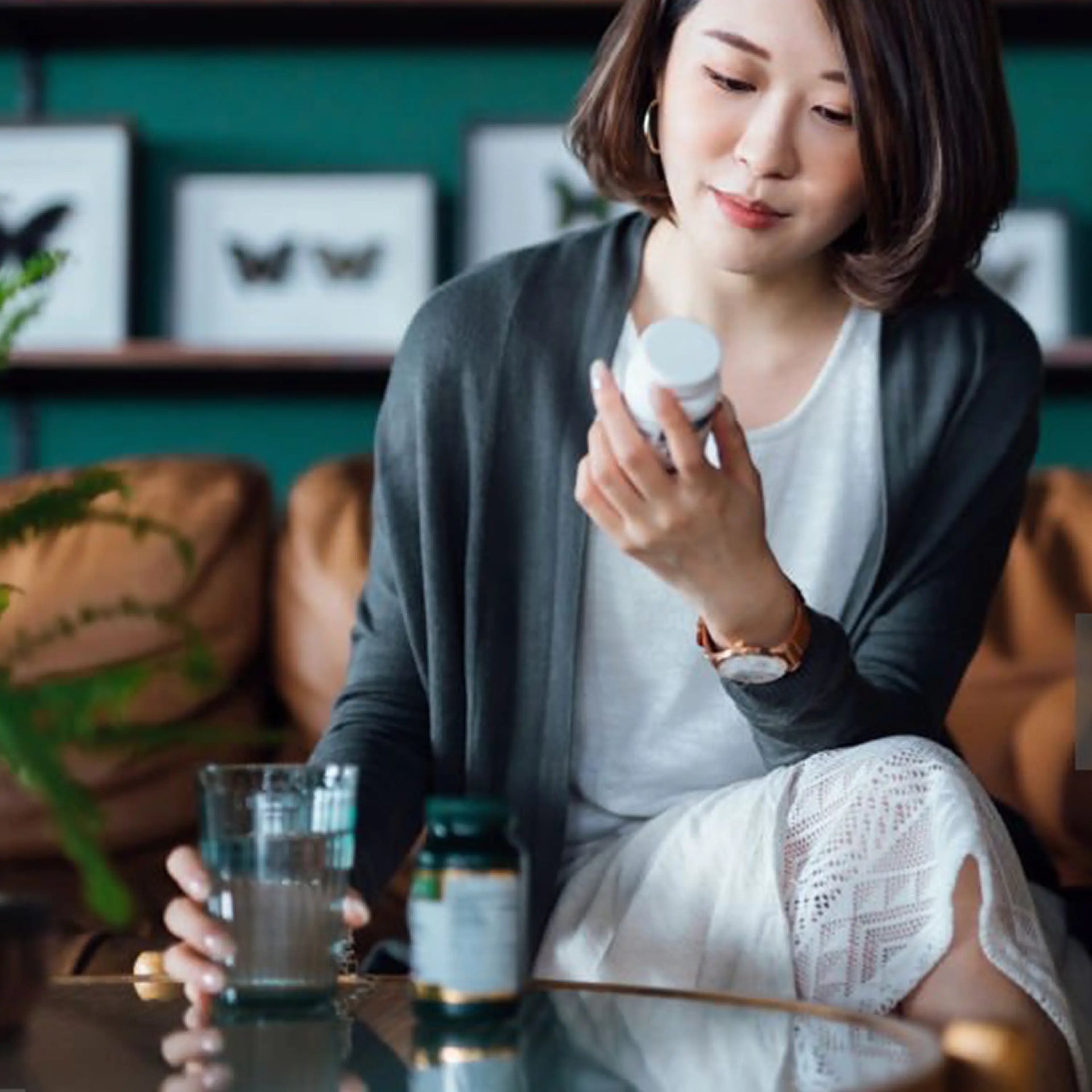 Mid-age woman holding a bottle of supplements.
