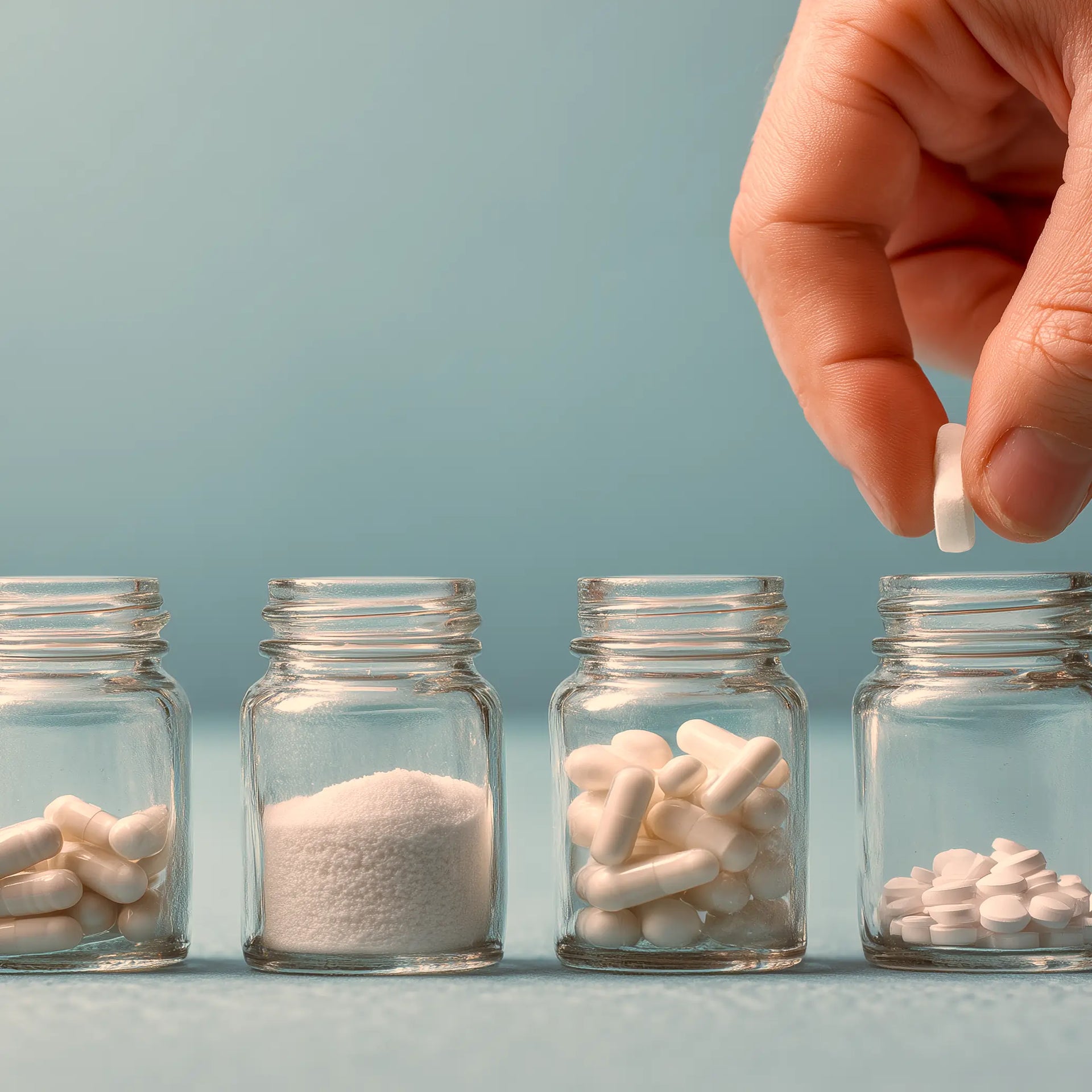 Four small containers of power and pill supplements.