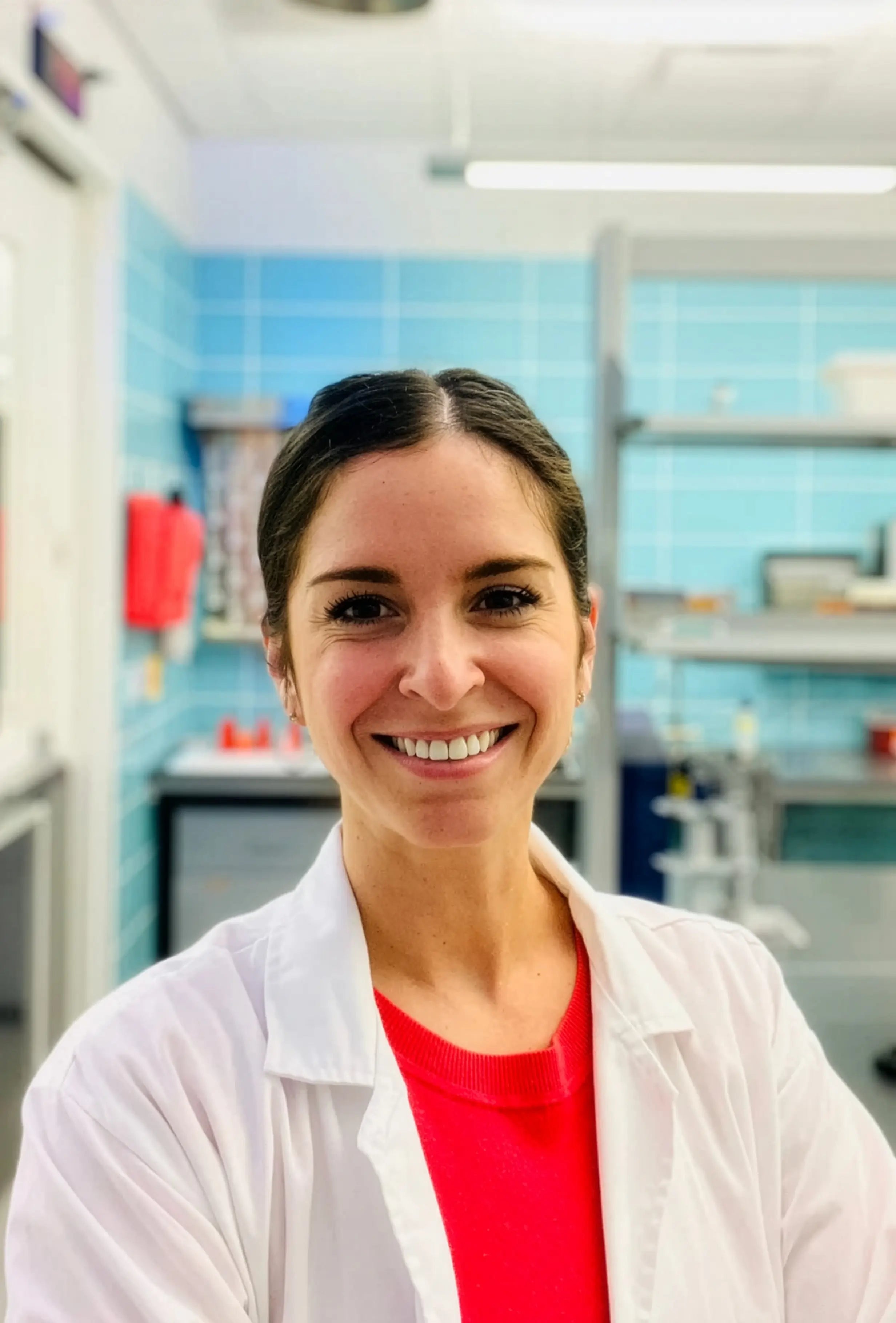 Person wearing a white lab coat in a laboratory setting